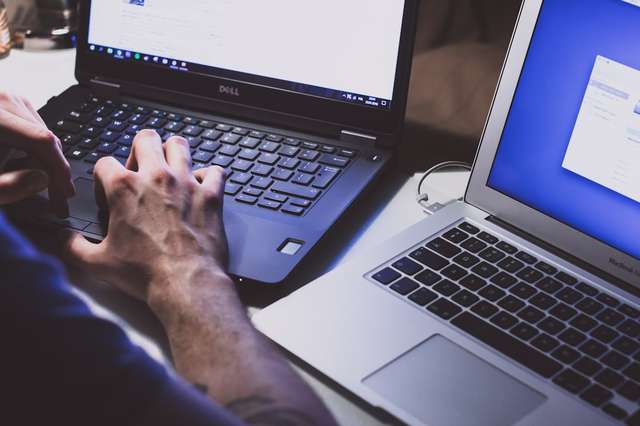 Person using laptop with digital privacy security icons and lock symbols