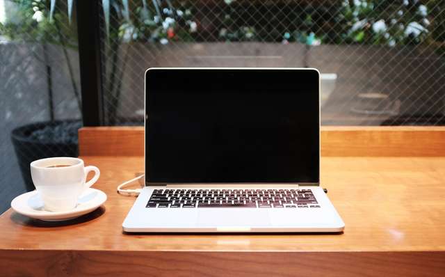 Remote worker using laptop with VPN security on public Wi-Fi network