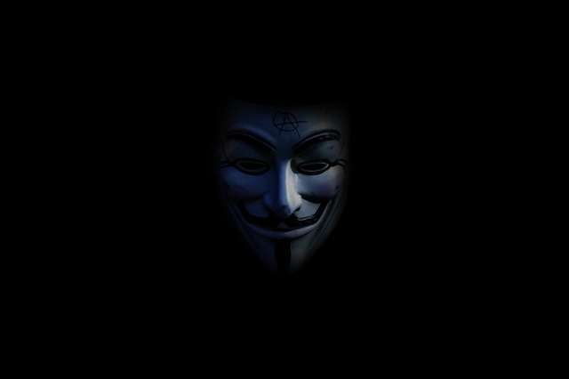 Person using laptop with privacy shield icon representing online anonymity and digital security