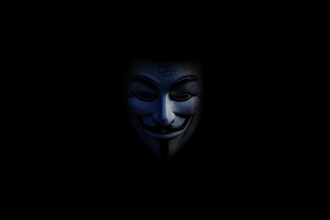 Person using laptop with privacy shield icon representing online anonymity and digital security