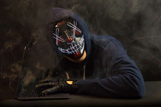 Cybercriminal exploiting unprotected browser session on computer screen with code