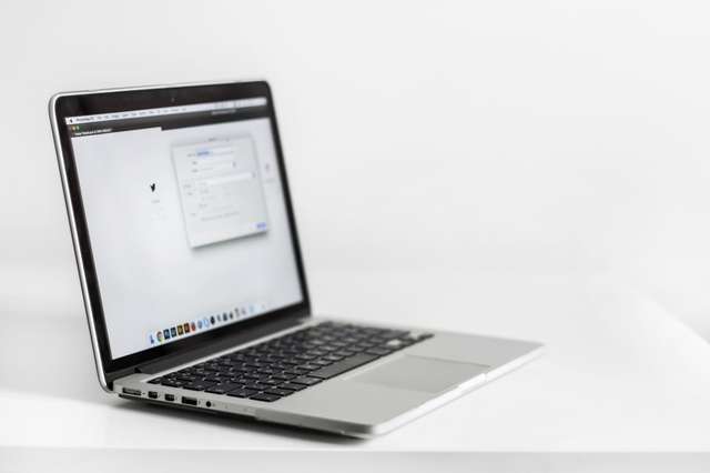Person using laptop with multiple browser tabs for online privacy and account isolation
